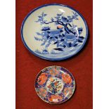 A large Japanese blue & white charger typically decorated with a bird on branch amongst foliage,