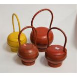 Four various lacquered containers of squat circular form with large loop handle