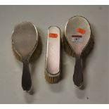A set of three 1970s silver backed brushes, each with engine turned decoration