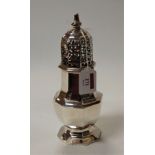A large late Victorian silver lighthouse sugar sifter having a pierced dome cover the body of fluted