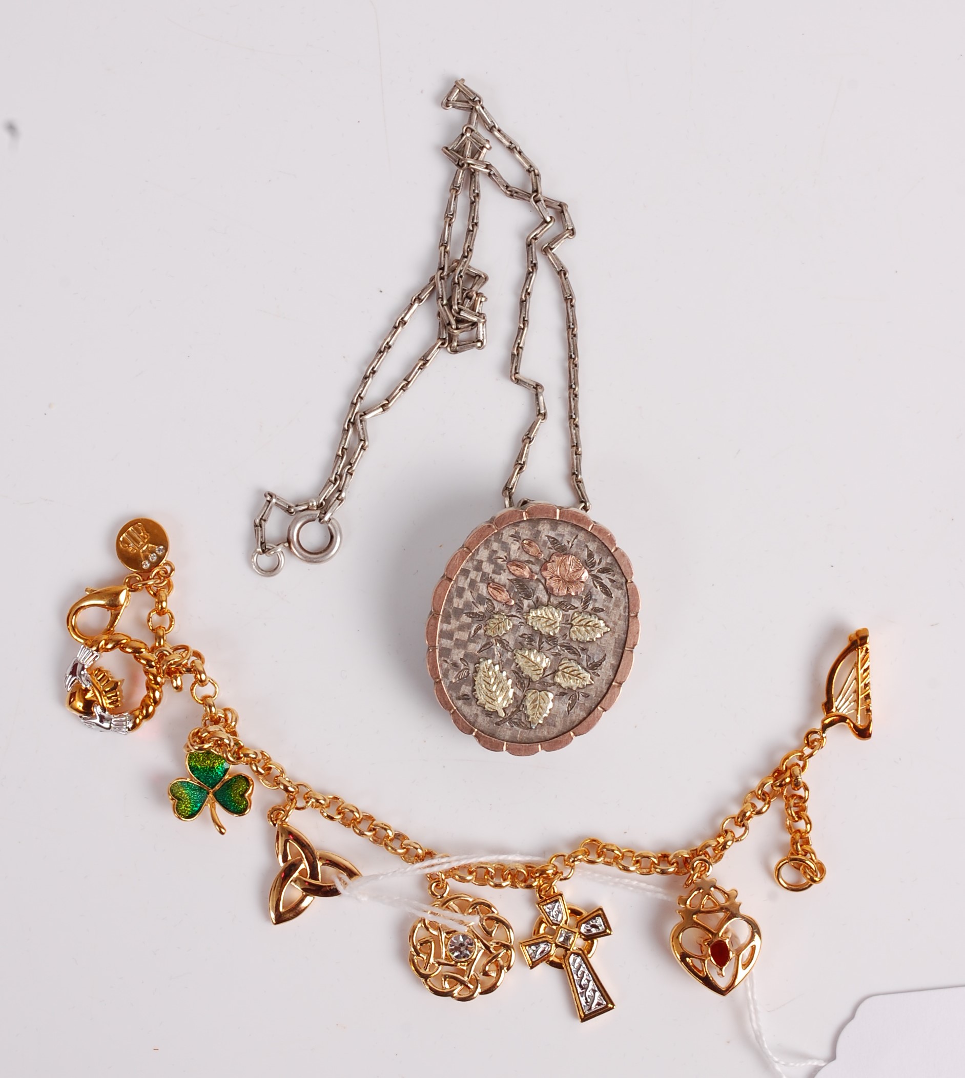 A gilt metal and paste set charm bracelet, in Brooks & Bentley case; together with a silver and gold