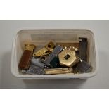 A small collection of assorted pocket cigarette lighters, cigar cutters etc