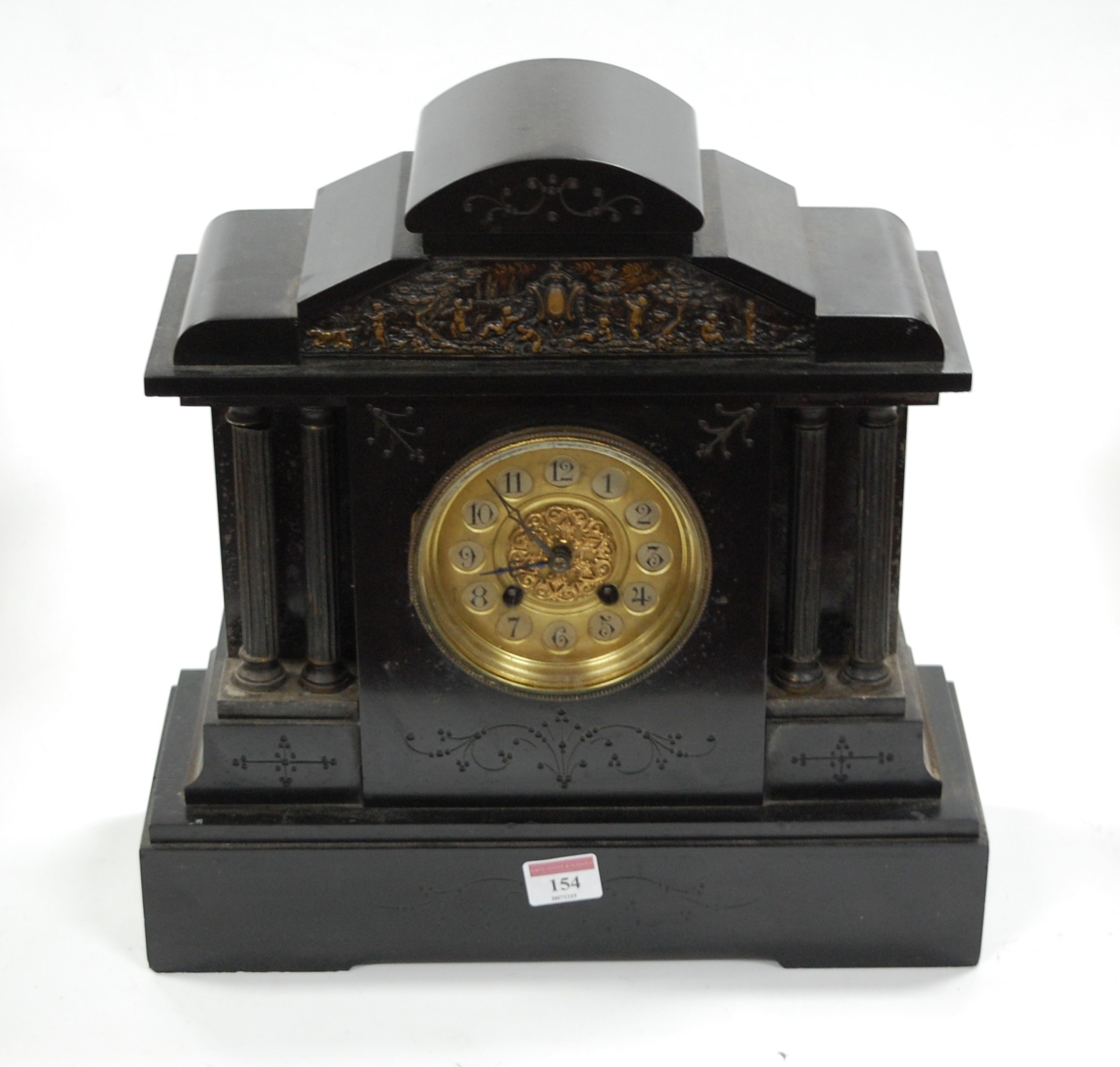A late Victorian black slate mantel clock having a circular gilt dial with Arabic numerals and eight