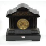 A late Victorian black slate mantel clock having a circular gilt dial with Arabic numerals and eight