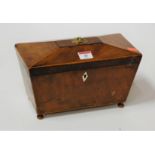A late George III mahogany tea caddy of sarcophagus form having a twin compartment interior and