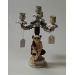 An early 20th century Meissen Dresden porcelain figural three-sconce candelabra, having floral