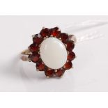 A silver gilt, opal and garnet set dress ring, size P