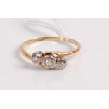 An 18ct gold and diamond three stone ring, the three old cut diamonds being illusion set, 2.8g, size