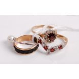 A 9ct gold, garnet and cz set wishbone ring; together with a Victorian yellow metal mourning ring