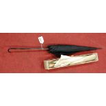 A late 19th century French parasol, having silk canopy and folding carved ivory handle, boxed;