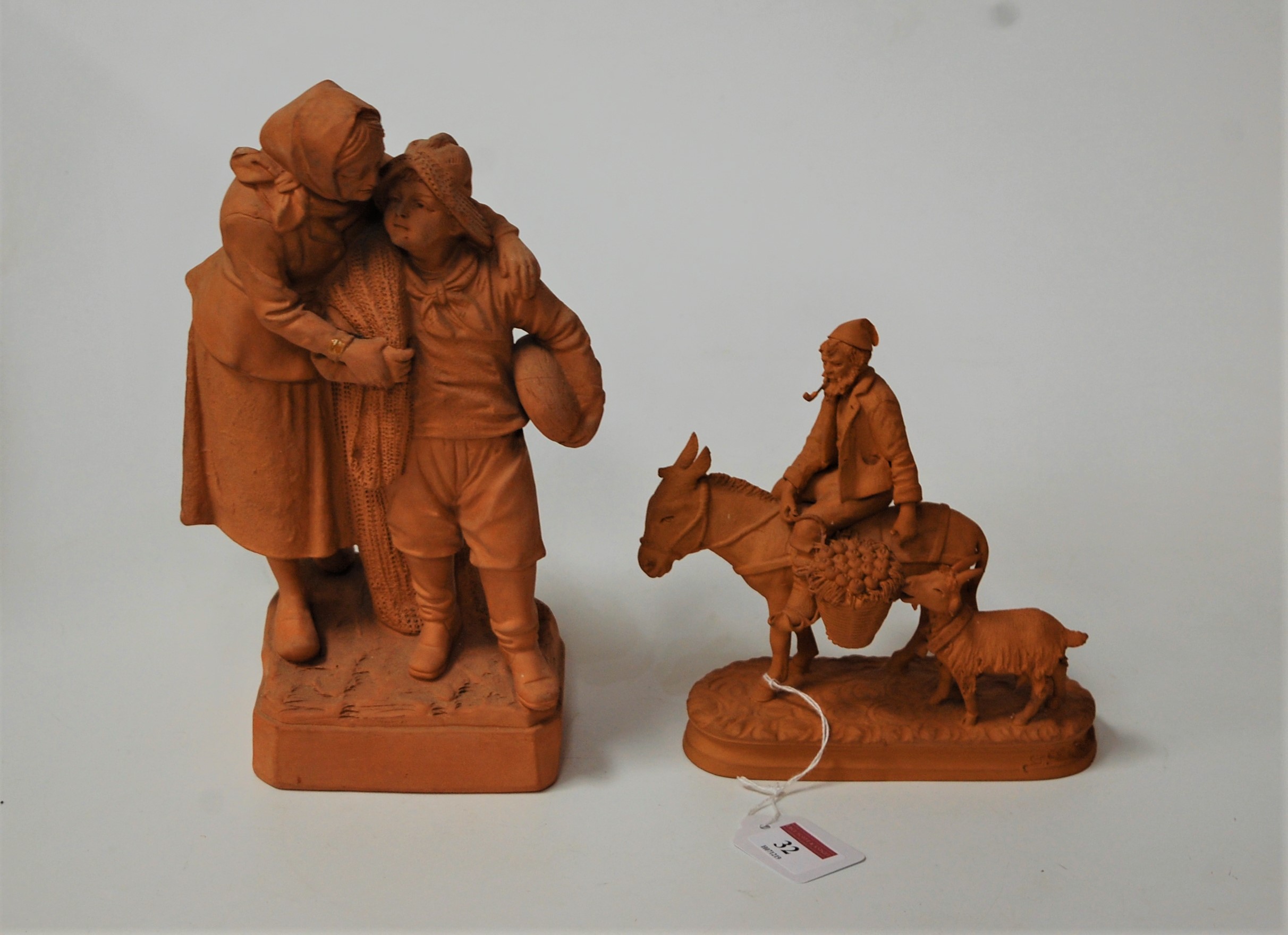 A modern Italian terracotta figure of a man on a donkey with a goat behind, height 18cm; together