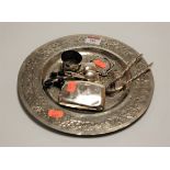 An eastern white metal plate, the centre engraved with various animals within a scrolling border,