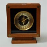 A modern teak cased World Time Clock with revolving dial showing various countries, height 29cm