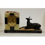 A French Art Deco black marble and onyx cased mantel clock, the octagonal dial signed Couzyn, having