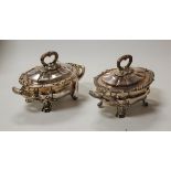 A pair of Victorian silver plated tureens and covers of squat oval form each having twin acanthus