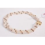 A freshwater pearl triple string choker, having engraved 9ct gold clasp, length 34.5cm
