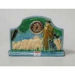 An early 20th century French Sarreguemines pottery mantel clock, the case relief decorated with a