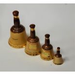 A Wade Bells Scotch Whisky bell together with three others (lacking contents)