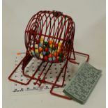 A bingo/lotto cage game with numbered balls, checkboard and tickets