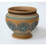 A large Doulton Lambeth silicone ware jardiniere on a brown ground, relief decorated with