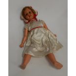 A mid 20th century continental celluloid doll having rolling blue eyes and open mouth with two top