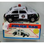 A boxed Zodiac Toys tinplate battery operated mystery action police car