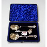 A set of three Edwardian silver sifting spoons, each with spirally turned stem and pierced terminal,