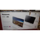 A Panasonic Viera DX650 49" Smart TV, having adjustable stand, remote control and a power lead, with