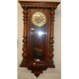 An early 20th century Vienna walnut droptrunk wall clock, having pendulum, h.95cm