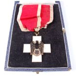 A German Red Cross Order neck badge with oak leaves, in a fitted leather case.