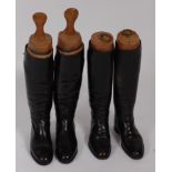 A pair of mid-20th century black leather calf length riding boots, with trees, together with one