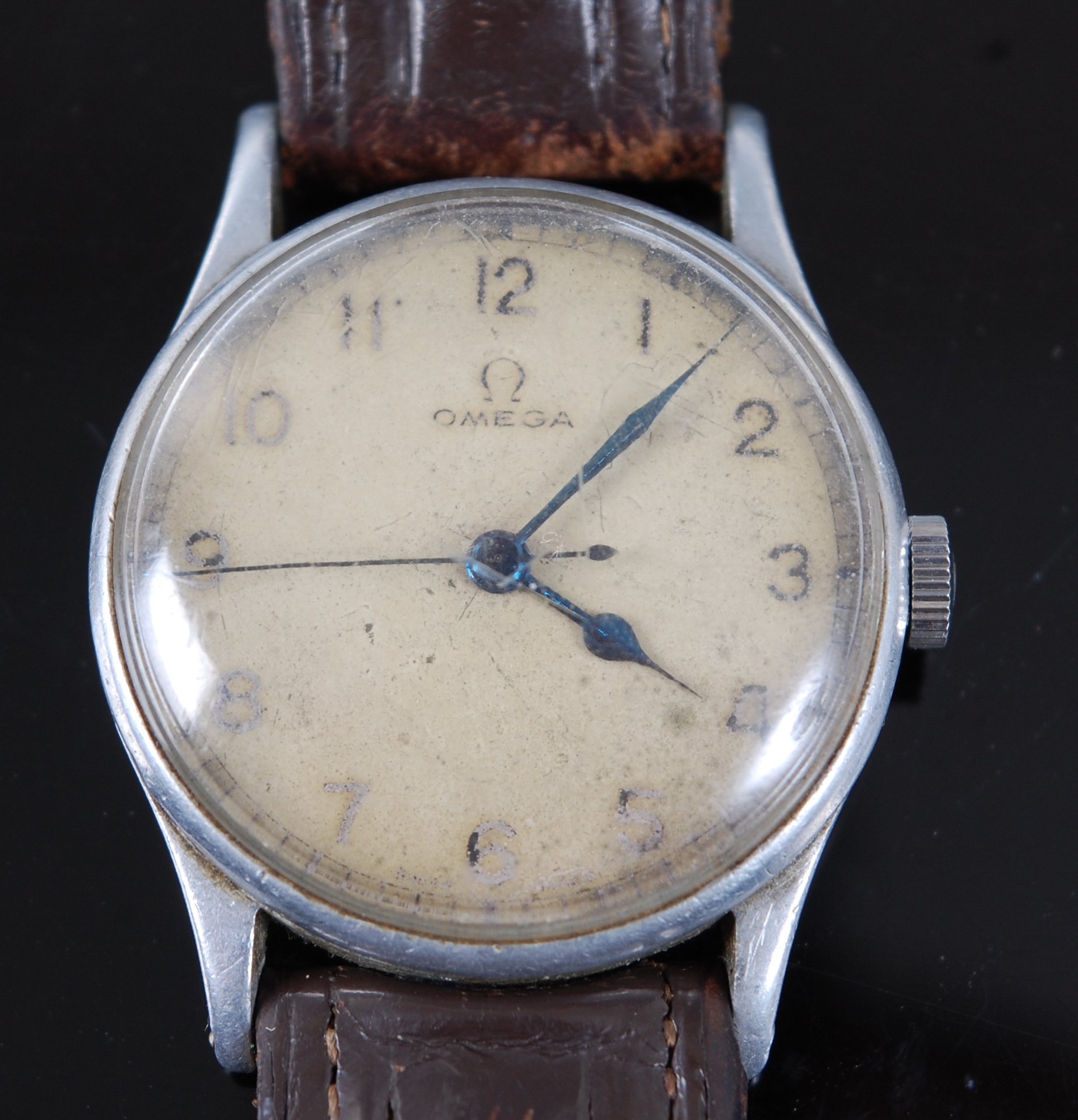 A gentleman's Omega military wristwatch having a white circular dial with Arabic numerals and