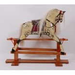 An early 20th century childs dapple-grey rocking horse, by J Collinson, having leather tack,