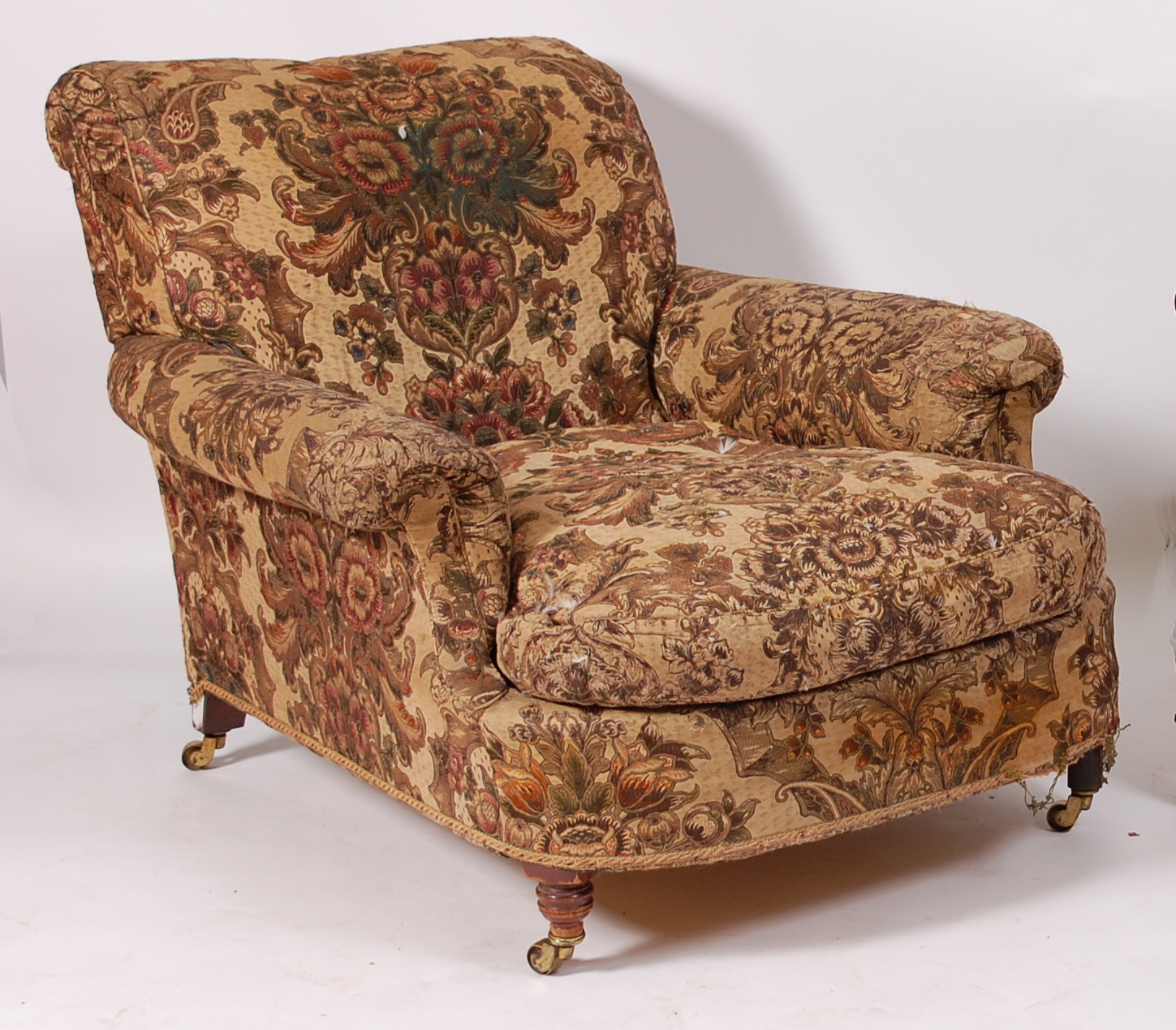 A Victorian oak framed armchair in the manner of Howard & Sons, having a deep seat, the whole