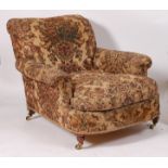 A Victorian oak framed armchair in the manner of Howard & Sons, having a deep seat, the whole