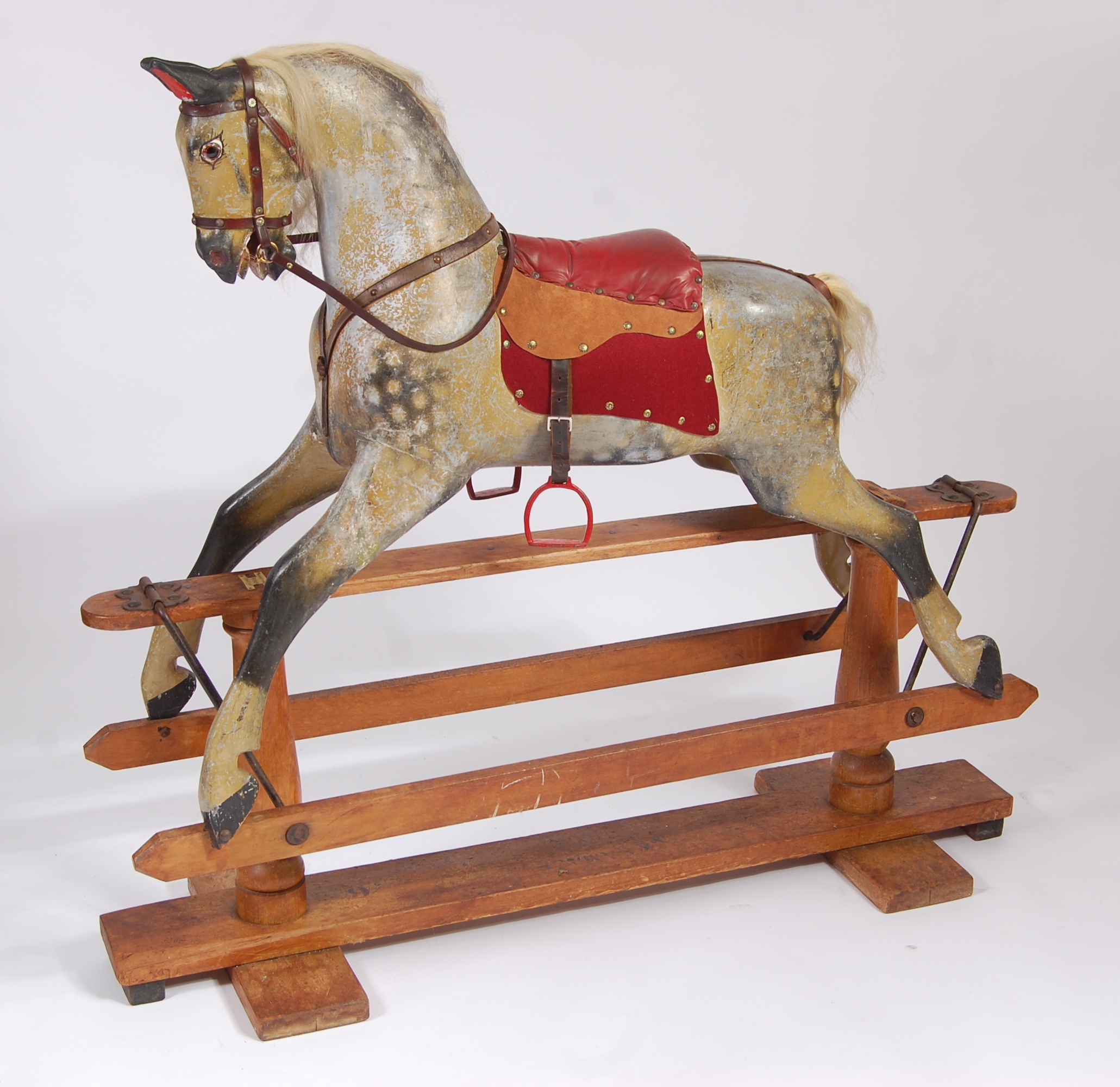 A good Victorian childs' dapple-grey rocking horse by Ayres of London, having horse hair mane and