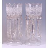 A pair of late Victorian clear glass lustres, each having gilded and white enamel bowls, faceted and