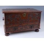 An antique oak Bible box, the hinged cover on steel loop hinges over a blind chip carved front
