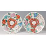 A pair of circa 1900 Chinese enamel decorated stoneware plates, each of circular dished form and