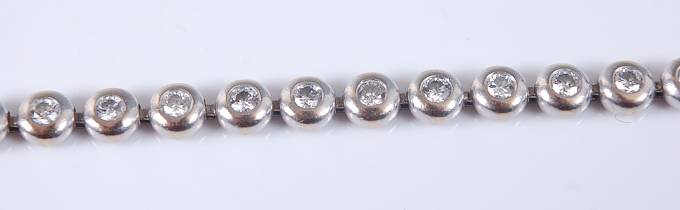An 18ct white gold diamond line bracelet, comprising 36 round brilliant cut diamonds in rubover - Image 2 of 2