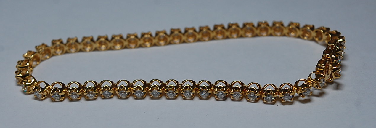 A Middle-Eastern 18ct yellow gold and diamond set tennis bracelet by Damas, with matching half - Image 4 of 6