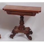 A mid-Victorian mahogany round cornered tea table, having a swivel fold-over top on a turned and