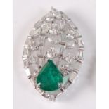 A white metal, emerald and diamond leaf shaped openwork pendant, featuring a pear shaped emerald