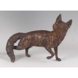 After Franz Bergmann - a large patinated bronze model of a fox, in standing pose, its front right