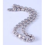 An 18ct white gold diamond line bracelet, comprising 36 round brilliant cut diamonds in rubover