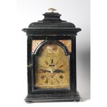 A late 18th century Dutch ebonised bracket clock, having engraved arched brass dial, with subsidiary