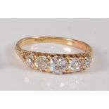 A Victorian yellow metal diamond half hoop eternity ring, featuring five graduated Old European