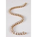 An 18ct yellow gold diamond tennis bracelet, featuring 42 round brilliant cut diamonds in claw