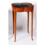 A late Victorian satinwood and inlaid display table, of shaped circular form, having glazed hinged