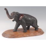 A Japanese Meiji period (1868-1912) bronze elephant, in standing pose, trunk raised, all over finely